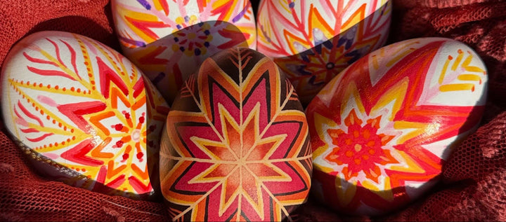 Pysanky wooden egg craft with hand-painted star designs on white wooden eggs using paint markers in bright spring colors