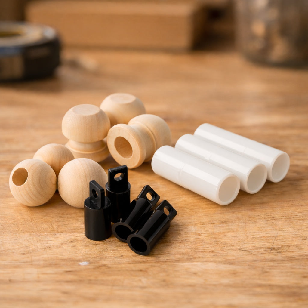 Wooden dowel caps and plastic dowel connectors arranged on a wooden workbench, showing accessories used to join or finish wooden dowel rods.